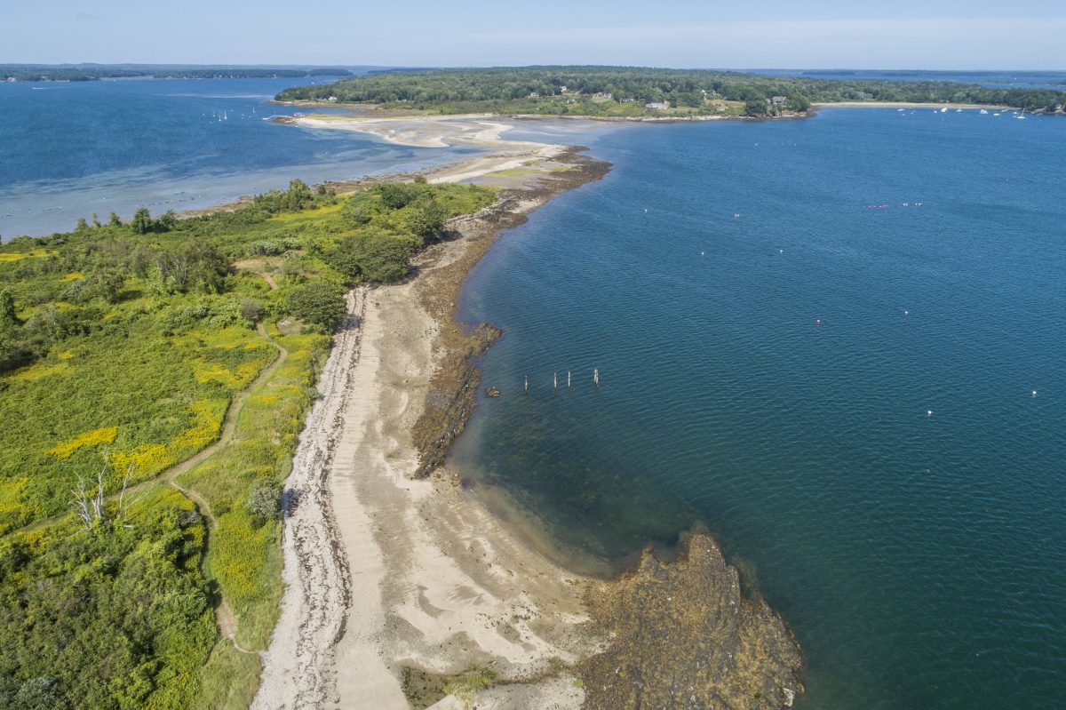 Little Chebeague Island is connected to Chebeague Island (top) by a sand bar at low tide. Portland, Maine.