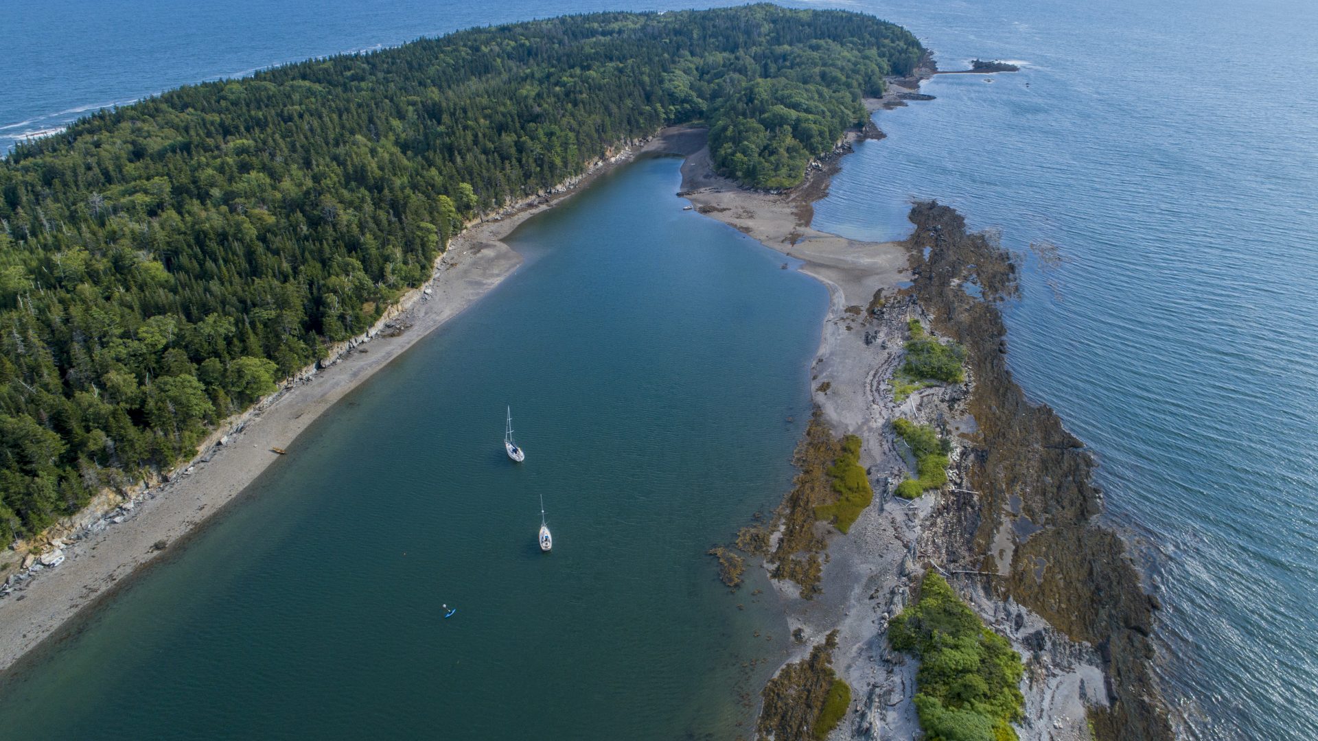 Sailboats moored in a cove on Jewell Island in Casco Bay. Portland, Maine.