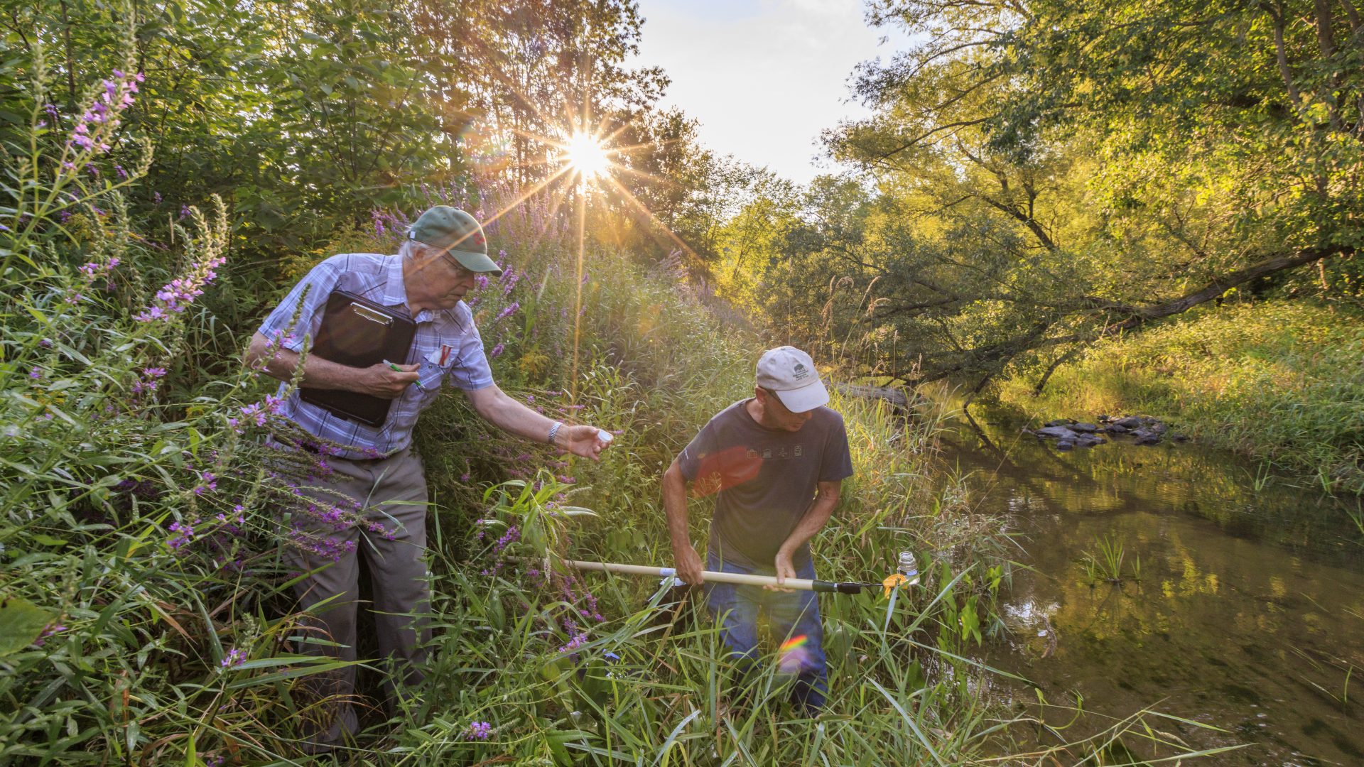 Volunteer water quality monitors sampling the Presumpscot River in Portland, Maine.